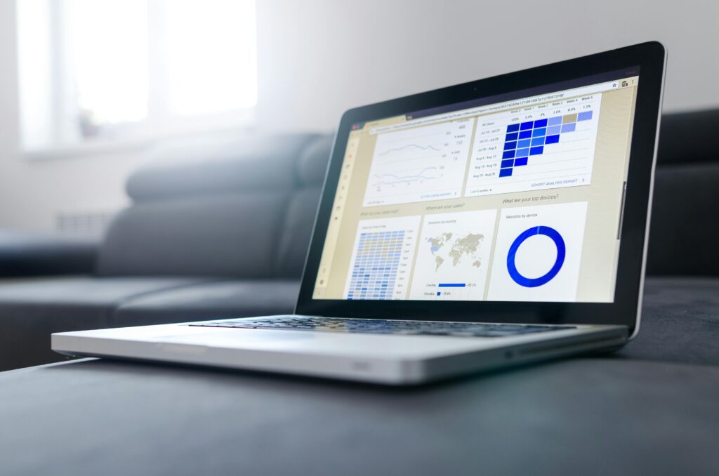 pexels photo 577210 577210 Sleek laptop showcasing data analytics and graphs on the screen in a bright room.